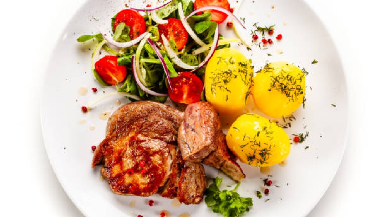 Fried pork and vegetables on white background