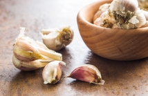 Fresh healthy garlic on kitchen table.