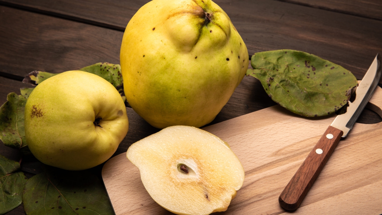 Fresh Quince fruit on wooden table. Cydonia oblonga